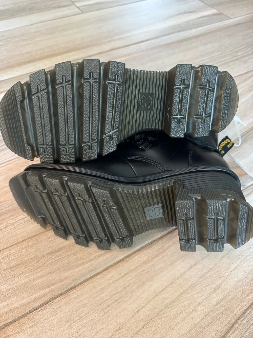 Dr. Martens Black Leather Lug-Sole Ankle Boots with Yellow Stitching